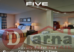 A fully furnished hotel unit managed by Holiday Inn Express for sale in The Five Mall, New Capital, with a down payment discount.
